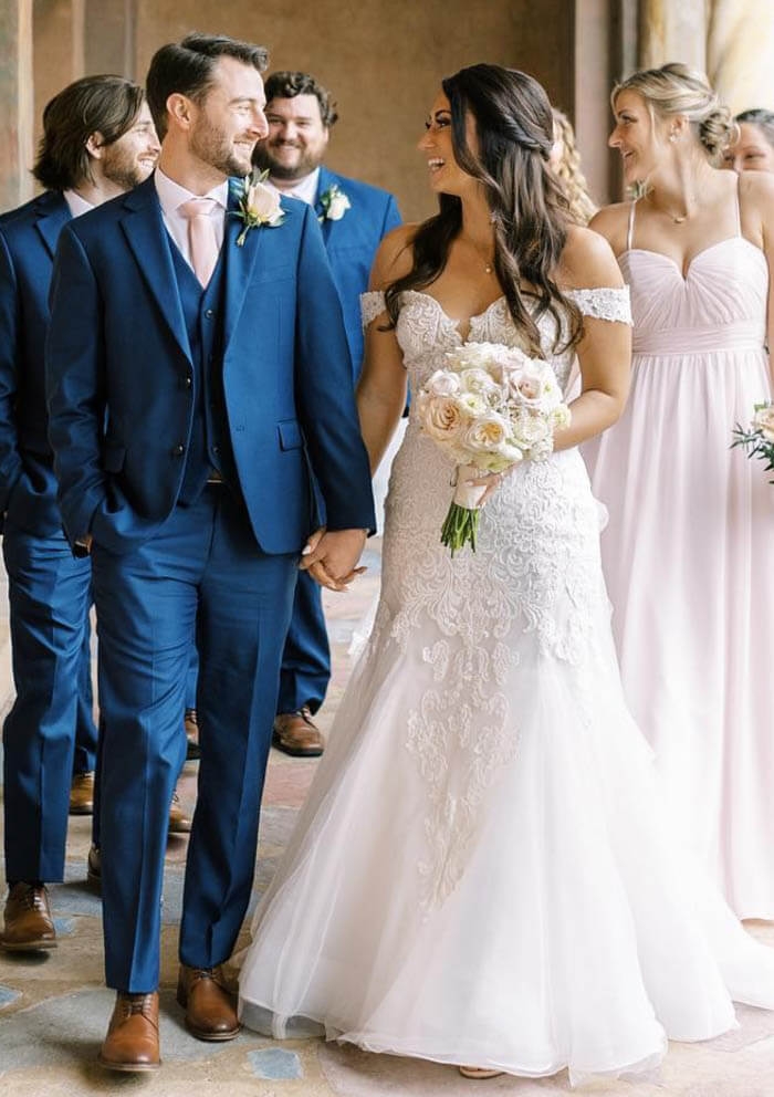 Сouple wearing a white gown and a blue suit