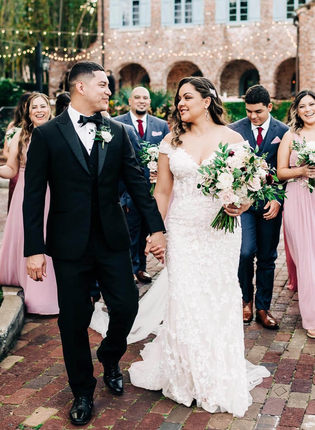 Сouple wearing a white gown and a black suit